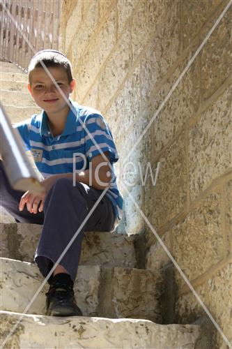  Boy sits on stairs