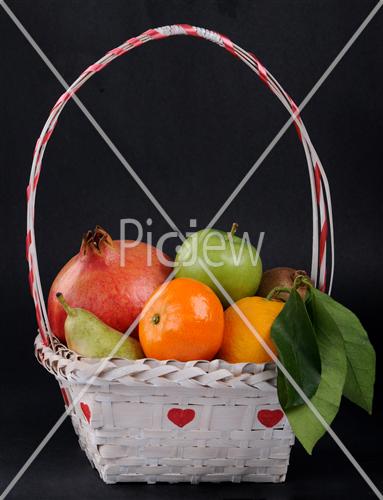 fruit in basket on black background