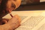 Sofer Stam during the writing of the Torah according to the rules of Halacha