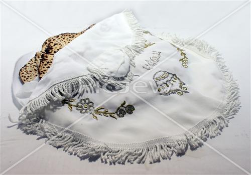 Hand matza in a silk covering