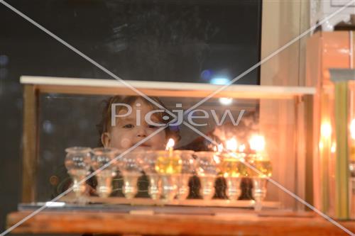 Lighting Hanukkah candles