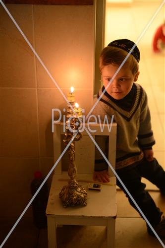 Lighting Hanukkah candles