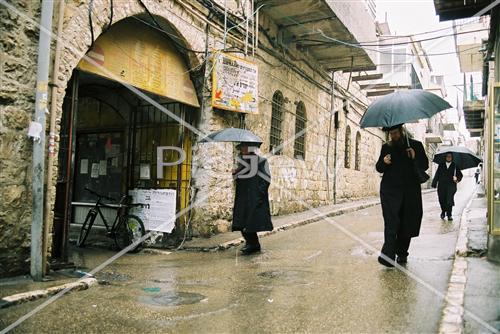 People walk in the rain