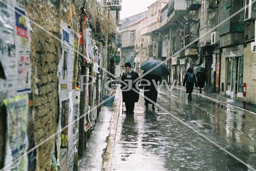 People walk in the rain