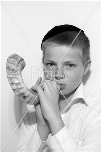 boy blows in the shofar