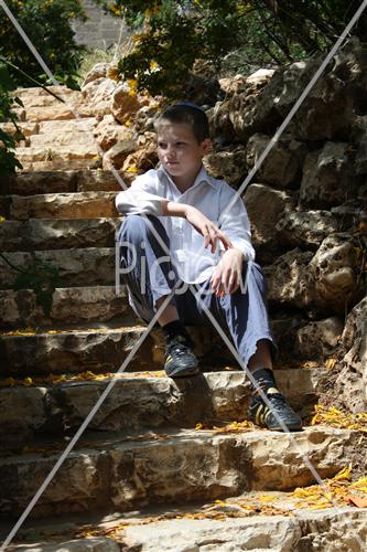  Boy sits on stairs