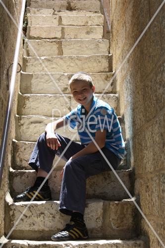  Boy sits on stairs