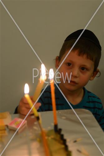 Lighting Hanukkah candles