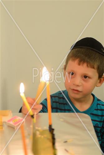 Lighting Hanukkah candles