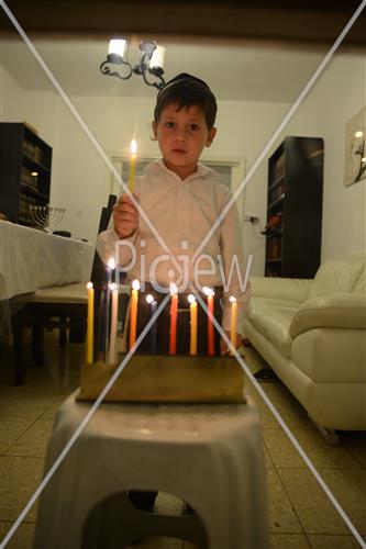 Lighting Hanukkah candles