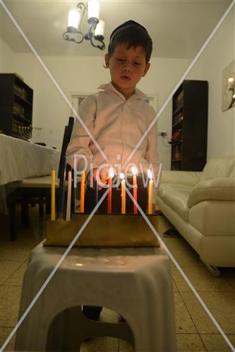 Lighting Hanukkah candles