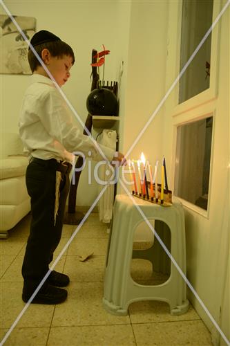 Lighting Hanukkah candles