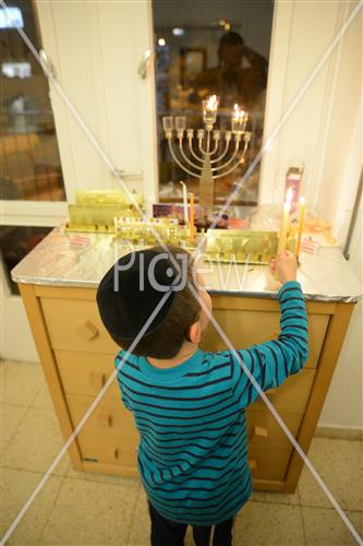 Lighting Hanukkah candles