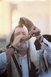 Man blowing Yemenite shofar