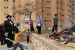 Jews burn leavened bread on Passover eve in the Upper Galilee town of Safed