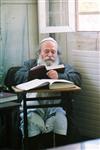 יהודי מבוגר לומד תורה בבית כנסת במאה שערים