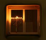 chanuka lights lit on the windowsill