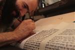 Sofer Stam during the writing of the Torah according to the rules of Halacha