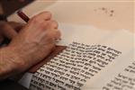 Sofer Stam during the writing of the Torah according to the rules of Halacha