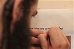 Sofer Stam during the writing of the Torah according to the rules of Halacha