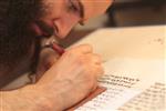 Sofer Stam during the writing of the Torah according to the rules of Halacha