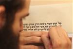 Sofer Stam during the writing of the Torah according to the rules of Halacha