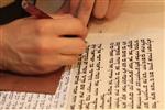 Sofer Stam during the writing of the Torah according to the rules of Halacha