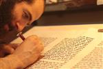 Sofer Stam during the writing of the Torah according to the rules of Halacha
