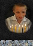 A child lights  Hanukkah candles