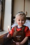 A child lights a menorah at the entrance facing the public domain