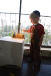 A child lights a menorah at the entrance facing the public domain