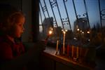 A child lights a menorah at the entrance facing the public domain