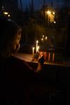 A child lights a menorah at the entrance facing the public domain