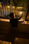 A child lights a menorah at the entrance facing the public domain