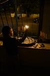 A child lights a menorah at the entrance facing the public domain