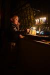 A child lights a menorah at the entrance facing the public domain