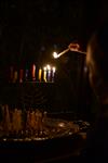 A child lights a menorah at the entrance facing the public domain