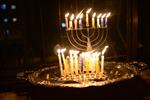 A child lights a menorah at the entrance facing the public domain