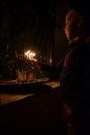 A child lights a menorah at the entrance facing the public domain