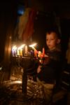 A child lights a menorah at the entrance facing the public domain