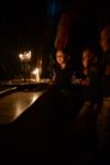 A child lights a menorah at the entrance facing the public domain