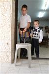 A child lights a menorah at the entrance facing the public domain