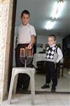 A child lights a menorah at the entrance facing the public domain