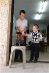 A child lights a menorah at the entrance facing the public domain