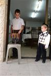 A child lights a menorah at the entrance facing the public domain