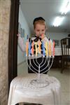 A child lights a menorah at the entrance facing the public domain