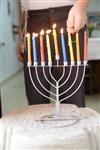 A child lights a menorah at the entrance facing the public domain