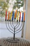 A child lights a menorah at the entrance facing the public domain