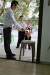 A child lights a menorah at the entrance facing the public domain