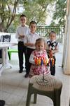 A child lights a menorah at the entrance facing the public domain